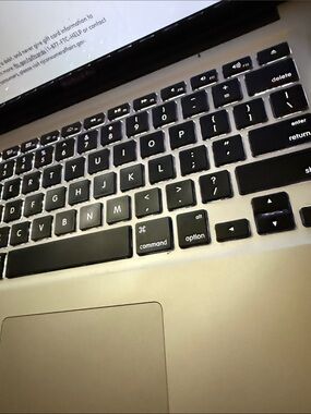 Apple Laptop with Silver Chassis and Black Backlit Keyboard